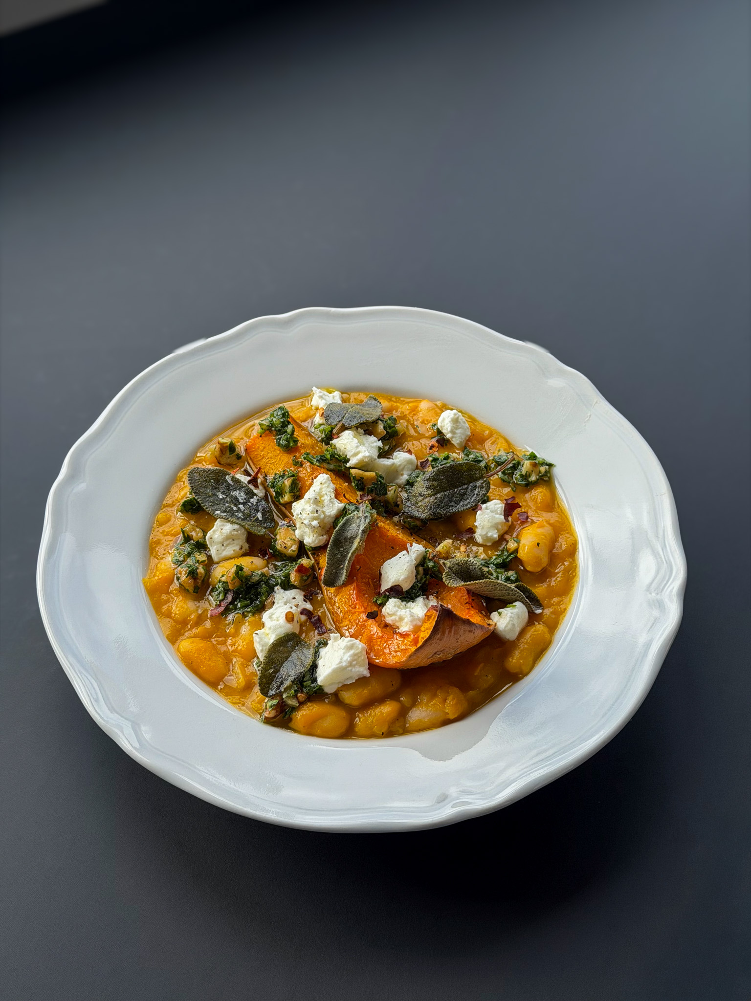 Photo of Braised Beans with Pumpkin, Sage, Walnut Gremolata & Meredith Goat’s Chèvre
